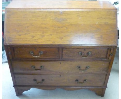 19th C oak bureau with fall front revealing fitted interior above two short and two long drawers, on raised bracket supports 