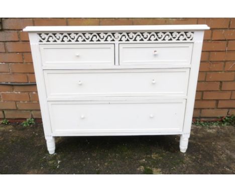 White painted chest of two short above two long drawers with fretwork panel to the top W91cm D37cm H75cm 