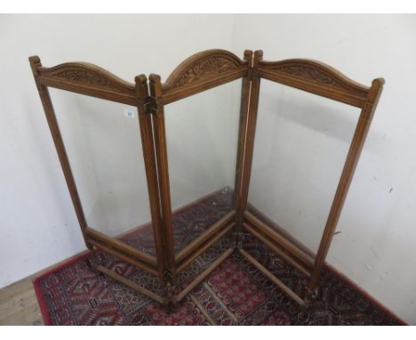 Edwardian oak framed two-fold screen, three glazed panels with carved cresting on turned supports with stretchers, panel W48c