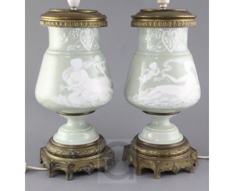 A pair of Paris porcelain pate-sur-pate celadon ground and ormolu mounted lamp bases, late 19th century, decorated with anthe