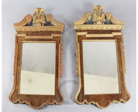 A pair of mid 18th century style carved giltwood and walnut wall mirrors, of architectural form with oak leaf and acorn decor