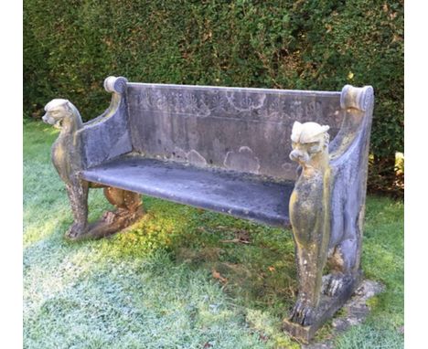 An Empire style reconstituted stone garden bench, with stylised leopard monopodia, 5ft 5.5in.