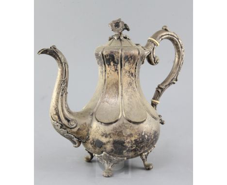 A 19th century Swedish silver pear shaped coffee pot with floral finial, on four scroll feet, dated for 1856, maker L. Larson