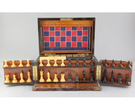A Victorian amboyna games compendium, fitted with wooden chessmen, draughts, cribbage and other games width 13in. height 7.5i