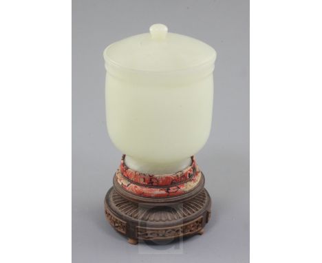 A Chinese pale celadon jade jar and cover, 19th / early 20th century, of plain form, the domed cover with button finial, the 