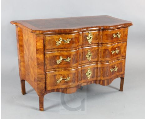 An 18th century Continental walnut commode fitted three serpentine drawers W.3ft9in. D.2ft. H.2ft6in.