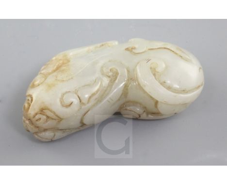 A Chinese pale celadon and russet jade figure of a recumbent beast, Qing dynasty, 5.1cm