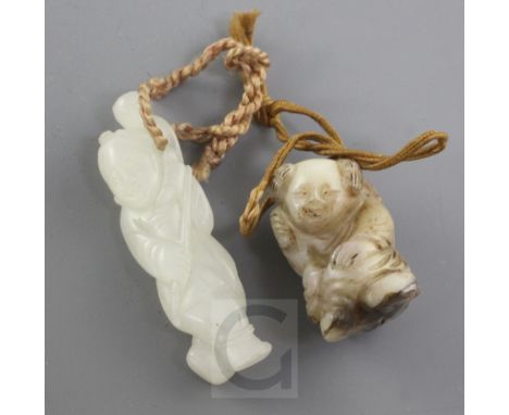 Two Chinese jade figures of boys, 19th century, the first in white jade with a boy with a monkey on his back, 4.9cm, the seco