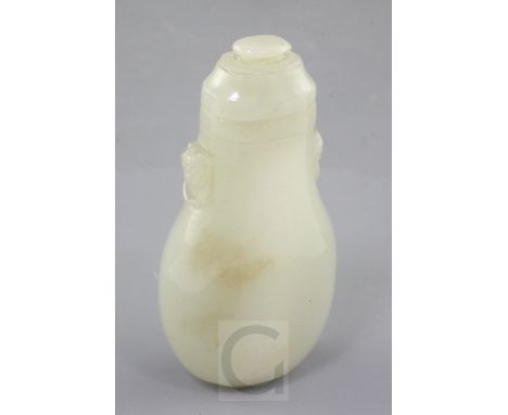 A Chinese pale celadon jade flattened baluster snuff bottle and cover, 19th century, the shoulders carved in relief with lion