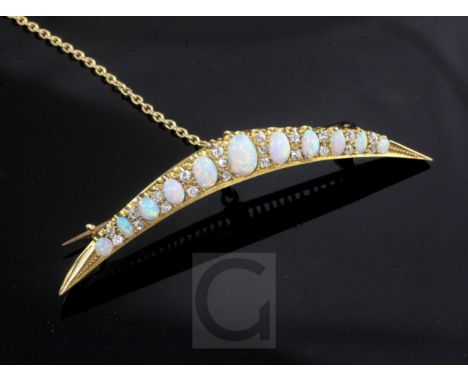 A Victorian style gold, graduated white opal and diamond set crescent brooch, with safety chain, 6cm.