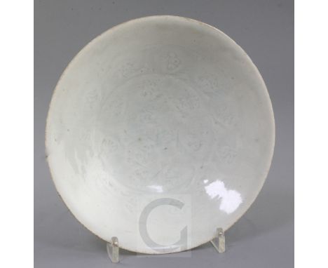 A Chinese Qingbai bowl, Song dynasty, the interior incised with a repeating design of foliage, on a circular foot, unglazed p