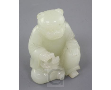 A Chinese pale celadon jade tiger-headed figure of a man, 18th / 19th century., seated and holding a basket with a lingzhi fu