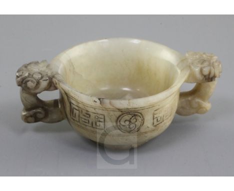 A Chinese white, grey and black veined jade two handled cup, 16th / 17th century, the slightly waisted body carved in low rel