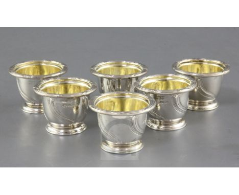 A set of six William IV silver egg cups by Paul Storr, with fluted spiral decoration, engraved crest and ribbon and foliate d