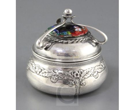 An Edwardian Arts & Crafts planished silver and enamel circular box and cover by Ramsden and Carr, of squat baluster form, wi