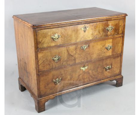 A George II walnut chest of three long drawers, on bracket feet 3ft3in. D.1ft9in. H.2ft7in.