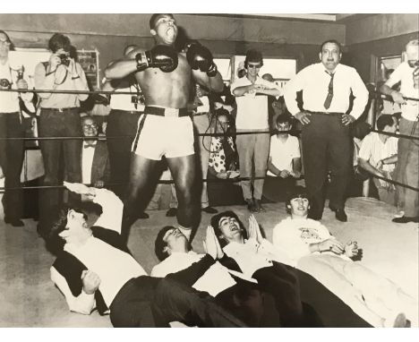 [Autograph / Muhammad Ali / The Beatles] Signed candid photographic print depicting Cassius Clay (1942-2016) and The Beatles 