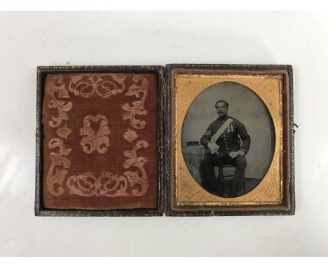 A Victorian tin-type photograph of a soldier of the British Army, cased