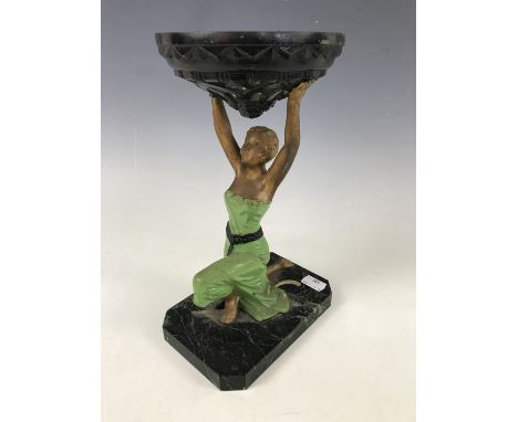 An inter-War Art Deco figural table lamp, modelled as a kneeling female holding aloft a torch (shade lacking), with 'Fabricat