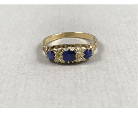 A vintage sapphire and diamond dress ring, comprising three round cut sapphires, the largest of approximately .45ct, interspe