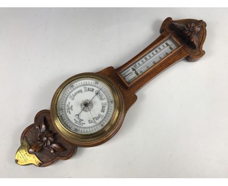 An early 20th Century carved oak banjo barometer bearing a brass plaque with engraved presentation inscription C Coy, 6th W R