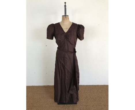 A 1930s chocolate-brown synthetic tumbling-leaf self-patterned evening dress, having a V-neck, gathered bust, short puffed sl