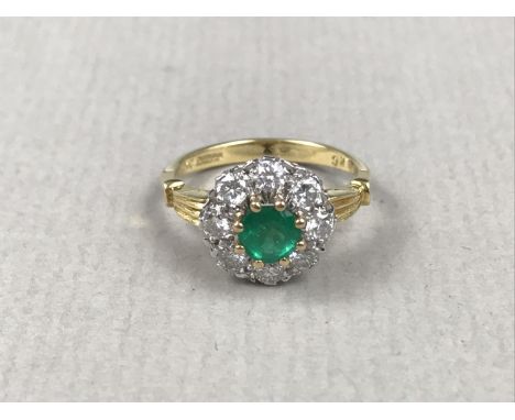 An emerald and diamond dress or engagement ring, comprising a circular emerald of approximately .5 ct, claw-set above a ring 