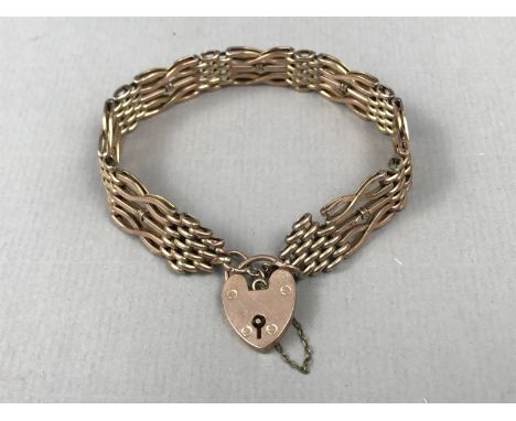 An early 20th Century yellow-metal gate-link bracelet with heart shaped padlock clasp, stamped 9ct, 9.4g