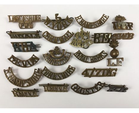 A quantity of British and Indian Army brass shoulder titles