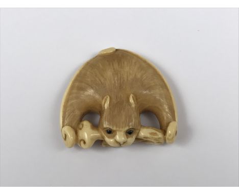 A Japanese ivory netsuke modelled as a bat, bearing inset mother-of-pearl plaque and signature, early 20th Century