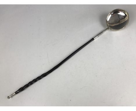 A George IV silver punch ladle with twisted baleen handle, having spirally fluted and foliate engraved decoration to the sock