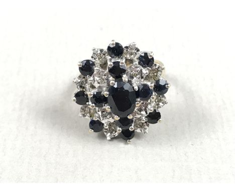 A flamboyant sapphire and diamond dress ring, the brilliants set in terraces, and the circular cut sapphires arranged as a st