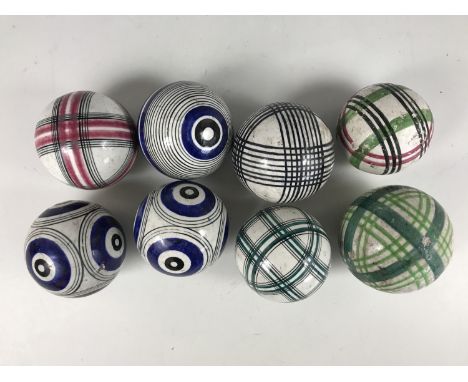 Eight 19th Century Scottish earthenware carpet bowls, hand painted with assorted geometric designs, 8 cm and smaller