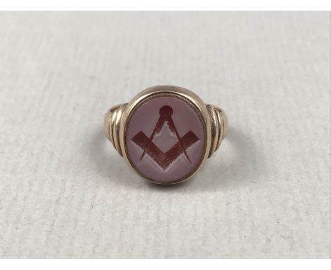 A late Victorian Masonic 9ct gold signet ring, having an engraved agate oval matrix