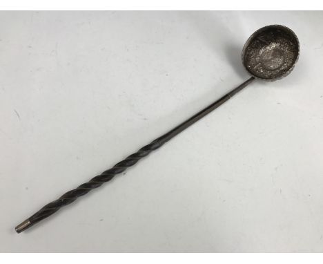 A Georgian white metal punch ladle, having baleen handle and repousse decorated bowl, the base incorporating a Queen Anne coi