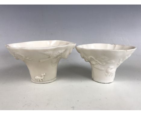 Two Kangxi Chinese blanc-de-chine libation cups, in imitation of rhinoceros horn, with applied decoration in the form of anim