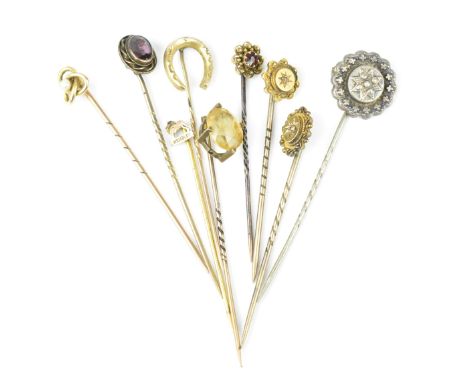 A collection of stick pins, to include some gold ones, with gemstones, two with diamond accent, one with a pearl, one with ce