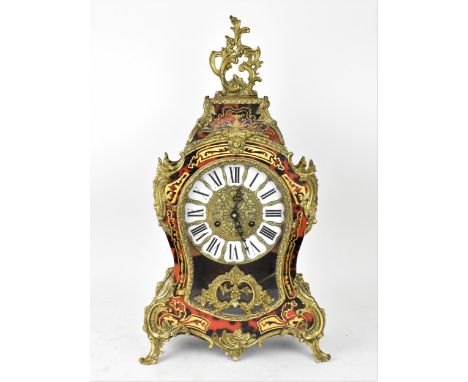 A 20th century French boulle work mantle clock having applied gilt metal C scroll and floral mounts with brass inlaid, the wh