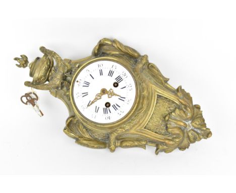 A 19th century French gilt metal Louis XV style wall hanging clock, the case having a torch finial and urn with floral swags,