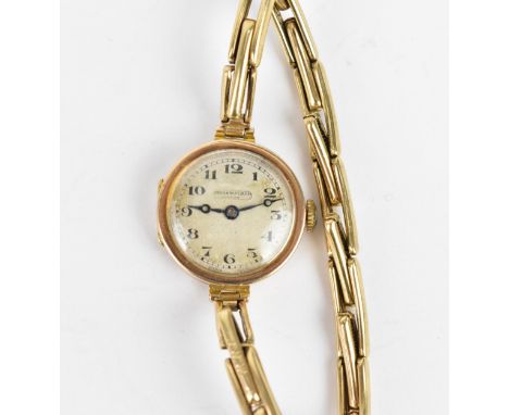 An early 20th century ladies 9ct gold cased manual wind wristwatch having a silvered dial signed James Walker London, with Ar