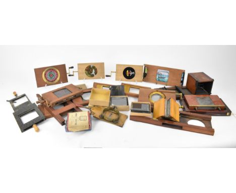 A collection of Victorian mahogany-framed magic lantern slides, to include five with winder handle, another with two plates d