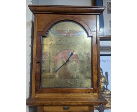 A mid 20th century electric Synchronome master longcase clock having an arched top Egyptian style dial with moonphase mechani