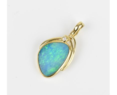 A 15ct yellow gold, black opal and diamond pendant, inset with a central freeform opal in a rub-over setting, with small diam