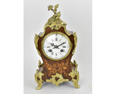 A late 19th century French rosewood marquetry inlaid mantle clock having applied gilt metal floral mounts and on scroll shape