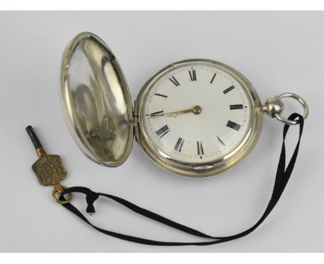 An early 19th century silver full hunter pocket watch having a white enamel dial, with gilt hands, Roman numerals, the fusee 