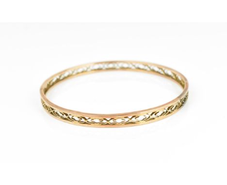 A 9ct rose gold bangle, with pierced frieze design, 8cm diameter, weight 11.5 grams 