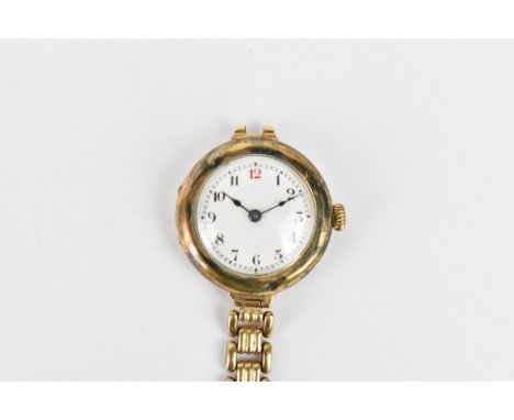 An early 20th century ladies 9ct gold cased manual wind wristwatch having a white enamel dial with Arabic numerals and blued 