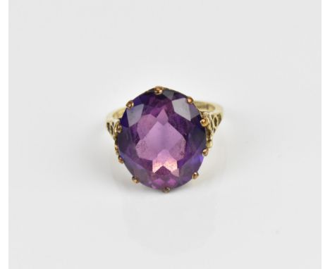 A 9ct yellow gold and alexandrite dress ring, with pierced mount, the shank hallmarked, size N 