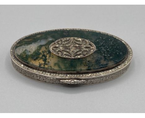 A silver oval snuff box with moss agate and marcasite decoration to cover, gilt interior 69.6g gross