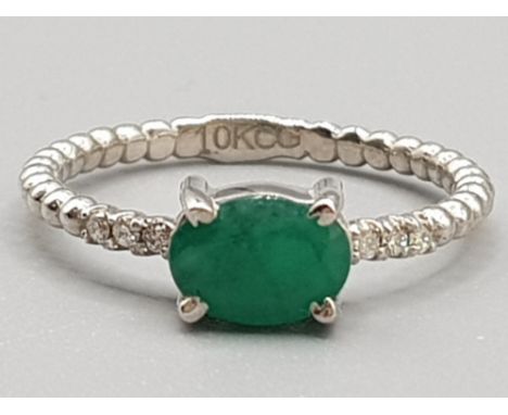 Brand new ex display 10ct white gold &amp; green stone ring, size K, 1.6g